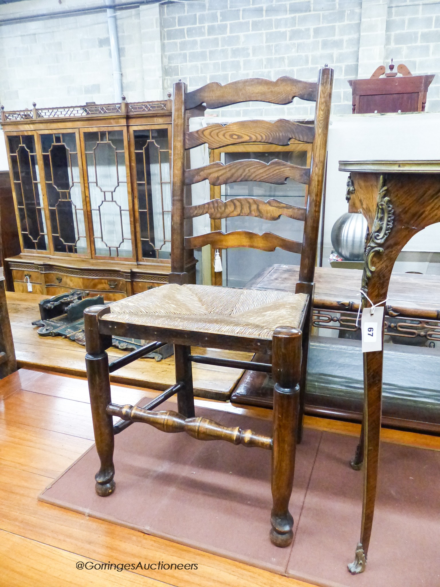 A set of four 18th century style ash rush seat ladderback dining chairs